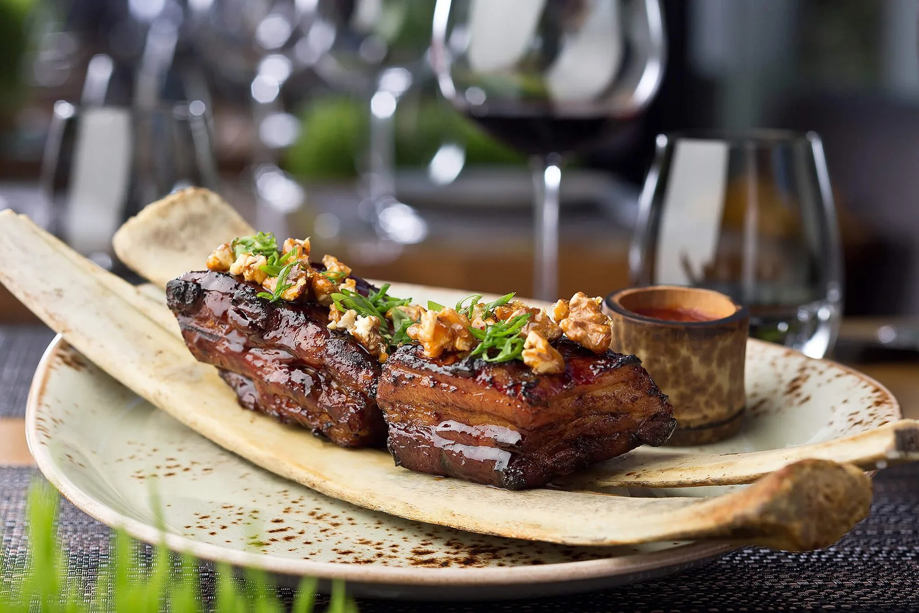 Pork belly with walnuts, plated for a restaurant menu