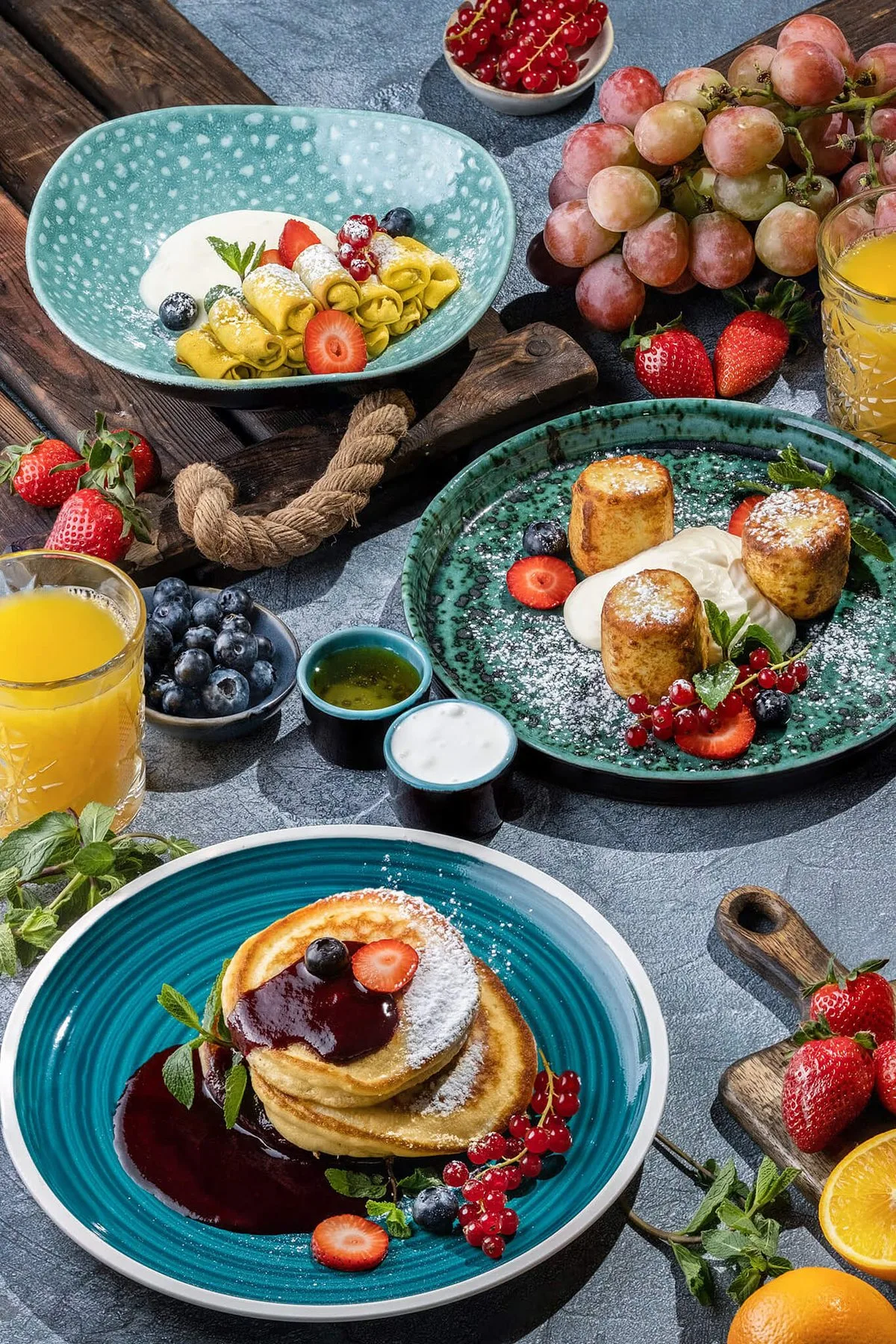 Breakfast spread with pancakes, eggs and fresh fruit
