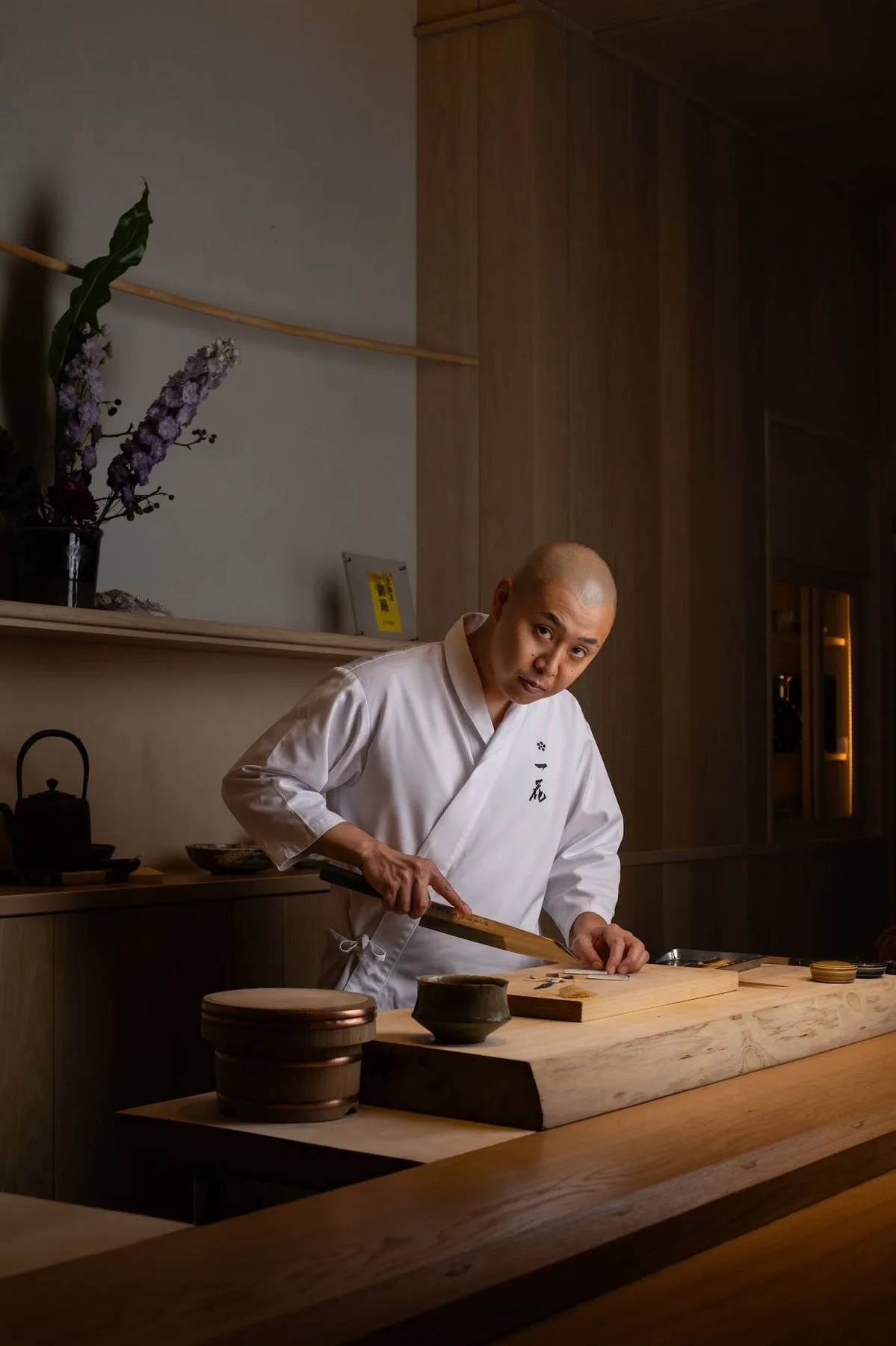 Chef preparing fish at a wooden counter