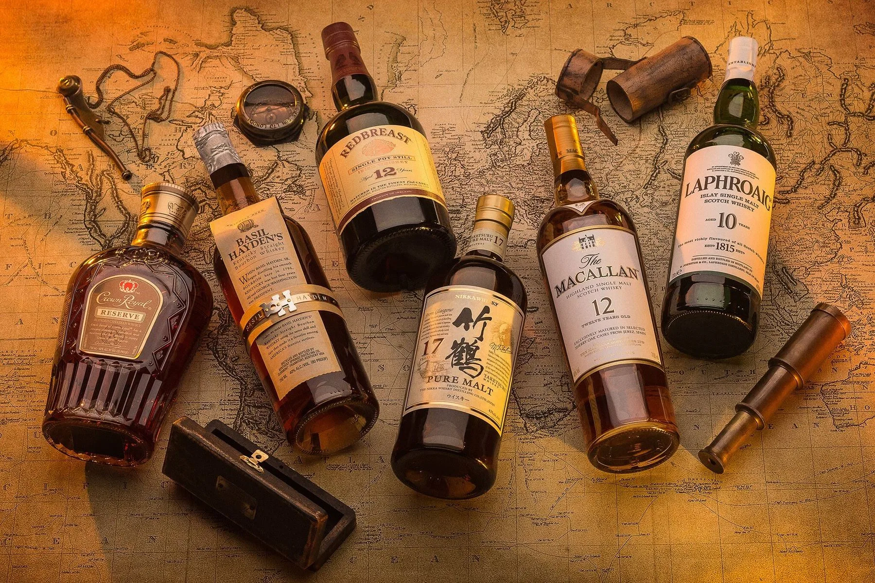 Single malt whisky bottles on an old map
