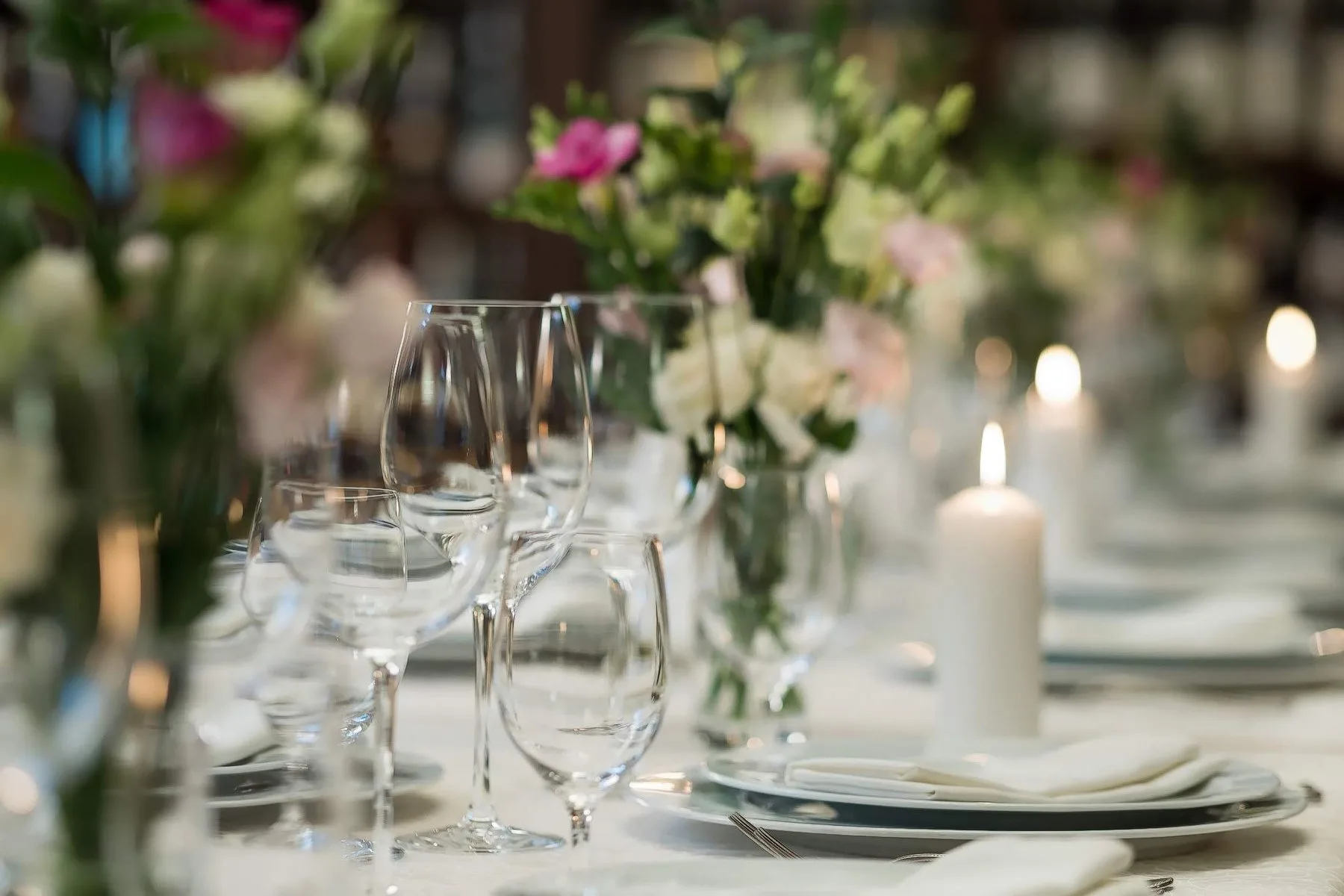 Restaurant table set with glasses, flowers and candles