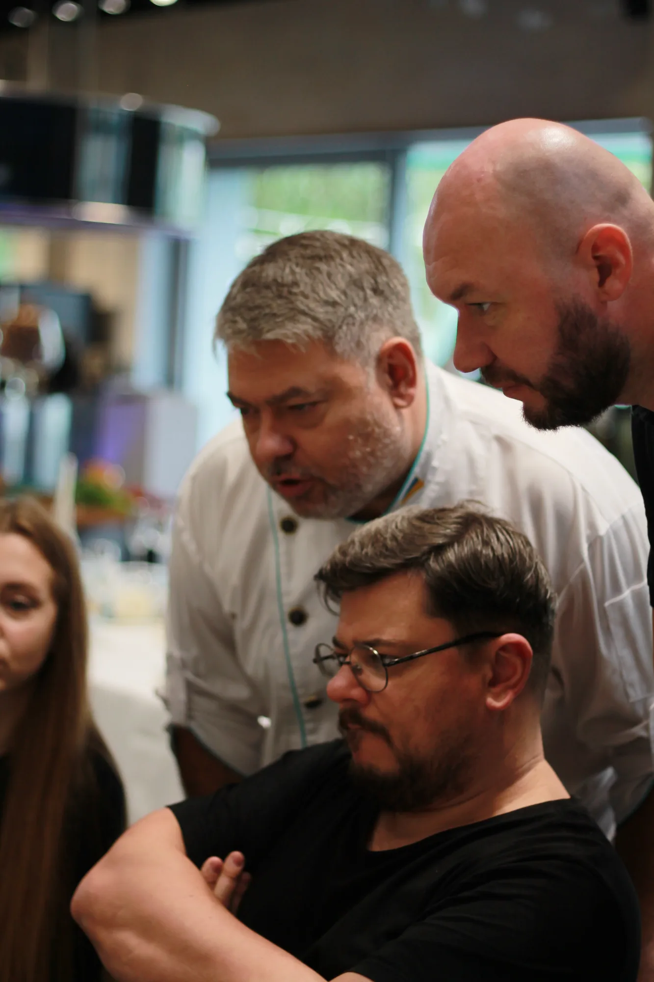 Alex Slyadnev reviewing frames on screen with the chef and the owner
